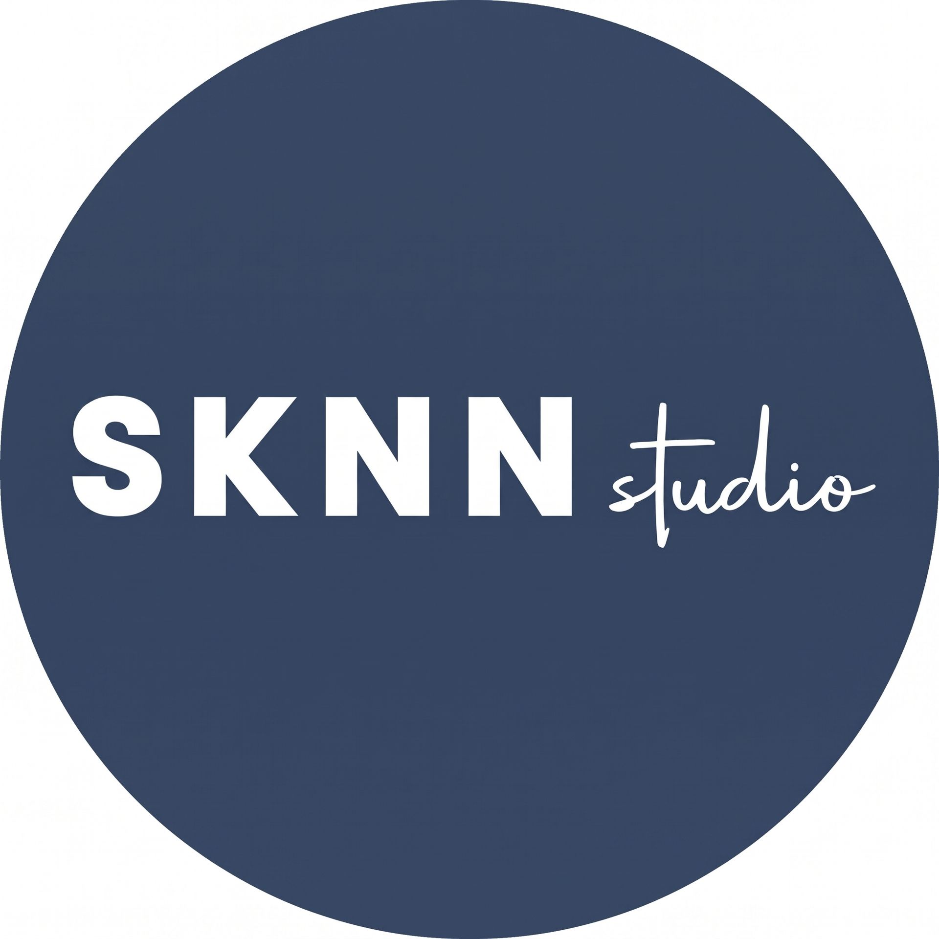 A pink circle with the words sknn studio written inside of it.