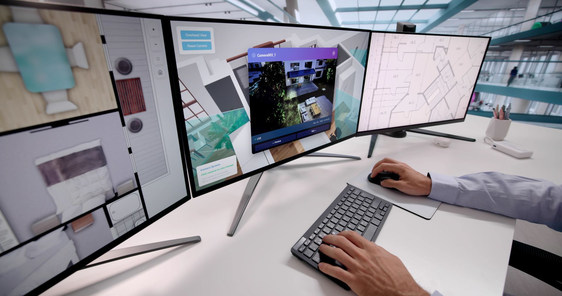 Une personne utilisant un poste de travail multi-écrans avec clavier et souris dans un bureau lumineux.