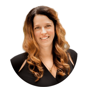 Smiling woman with long wavy auburn hair in a black top on a white background