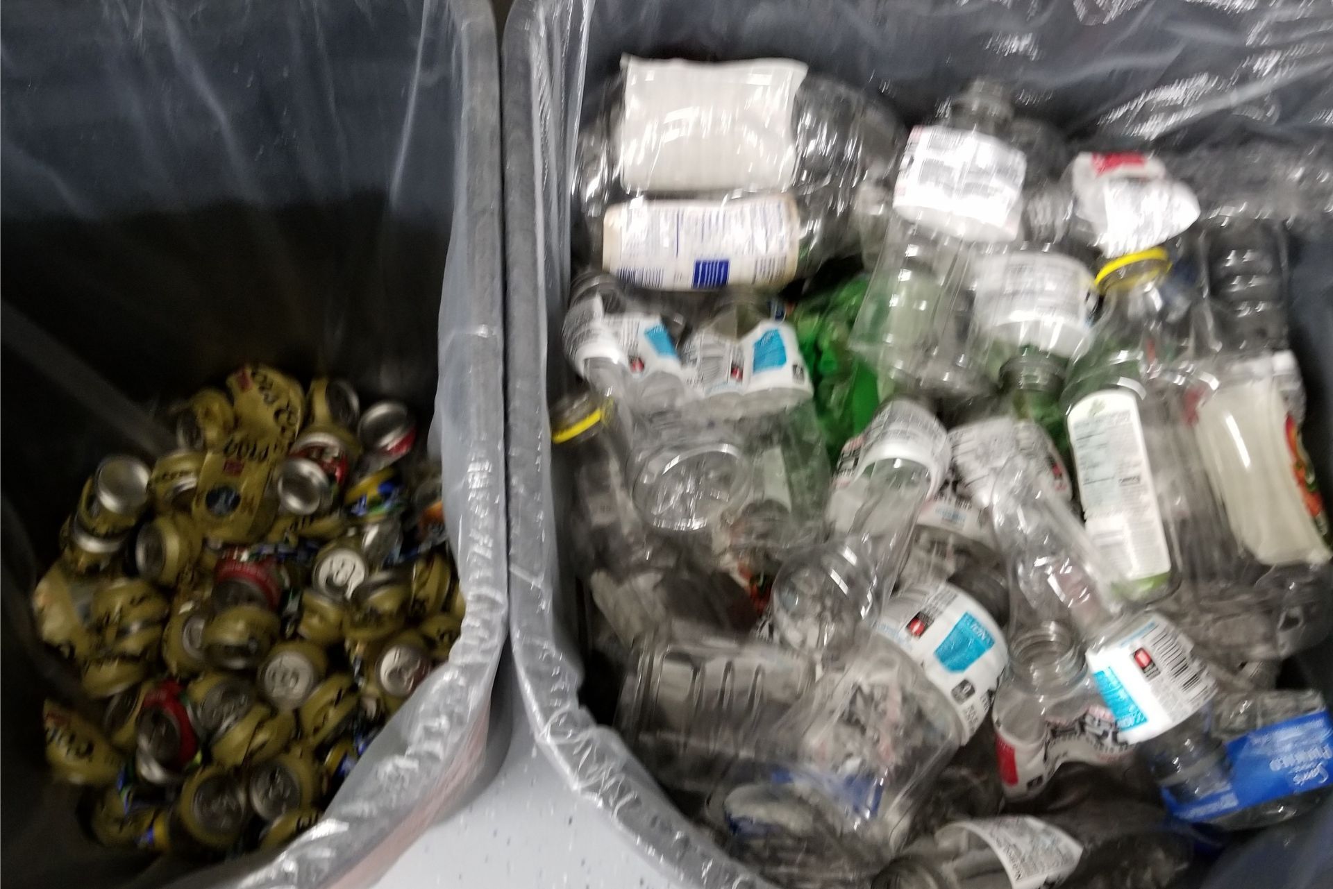 Two bins of recyclables: crushed aluminum cans on the left and empty plastic bottles on the right