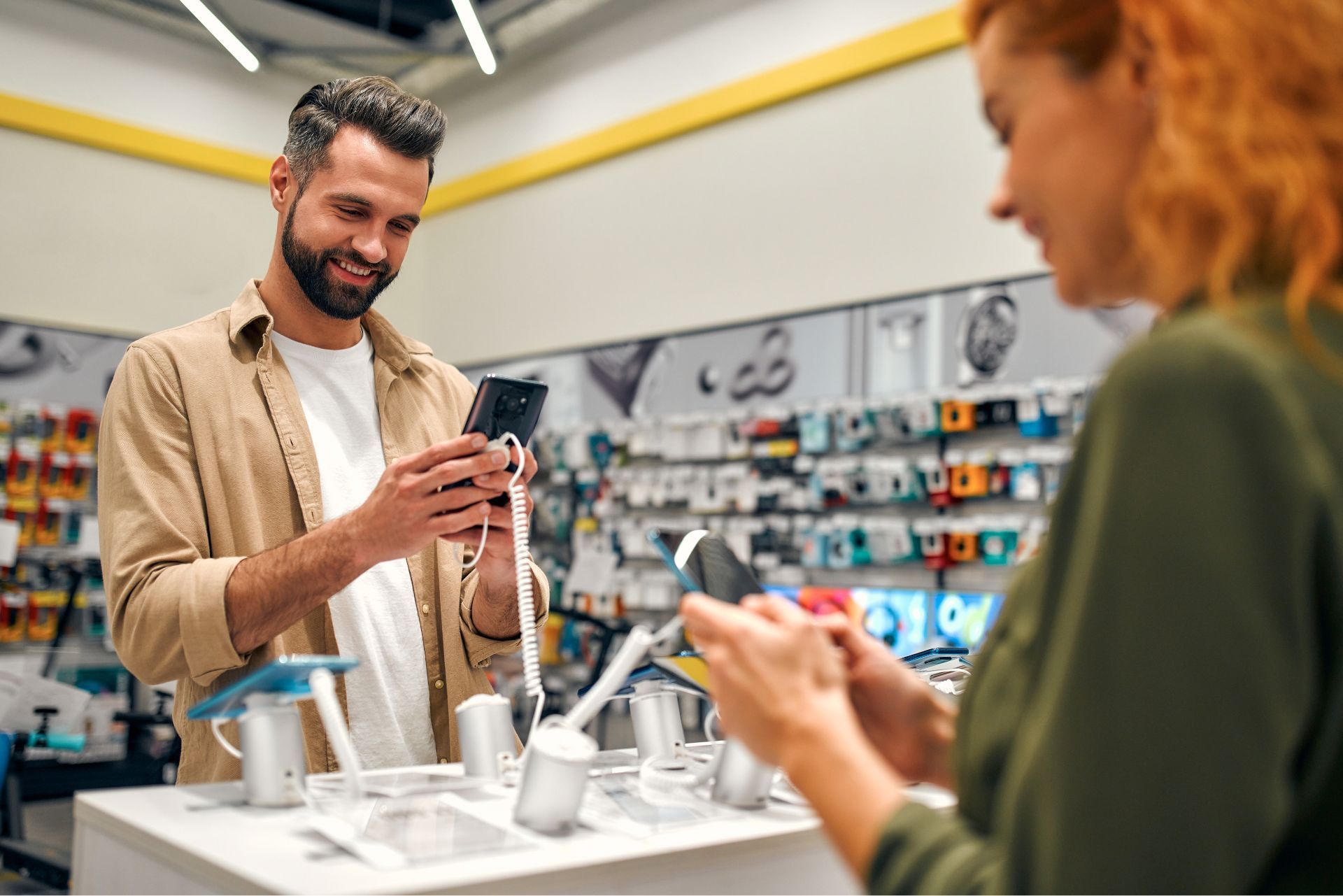 Two shoppers examining electric toothbrushes in a store aisle