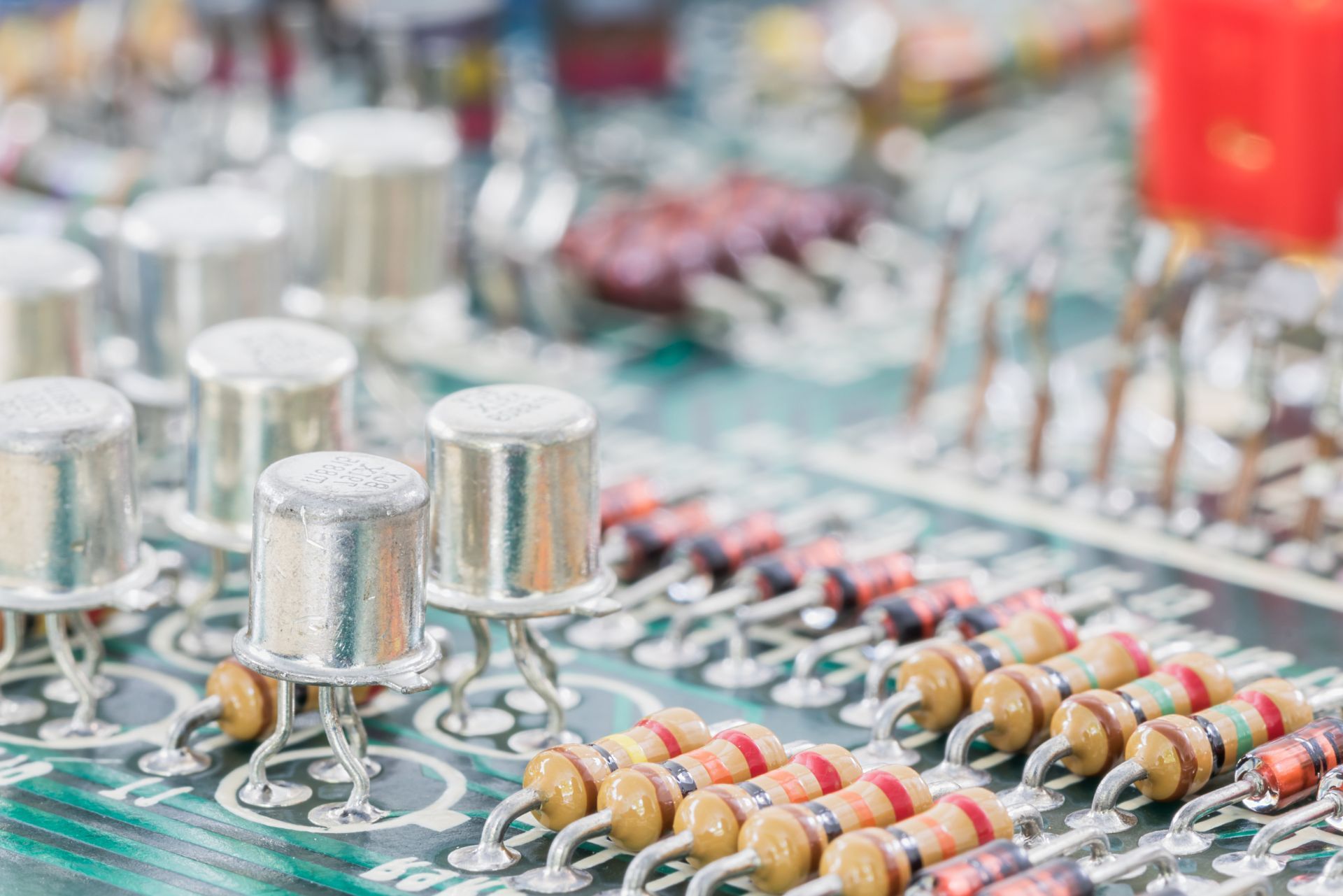 Close-up of a circuit board with resistors, capacitors, and metal components