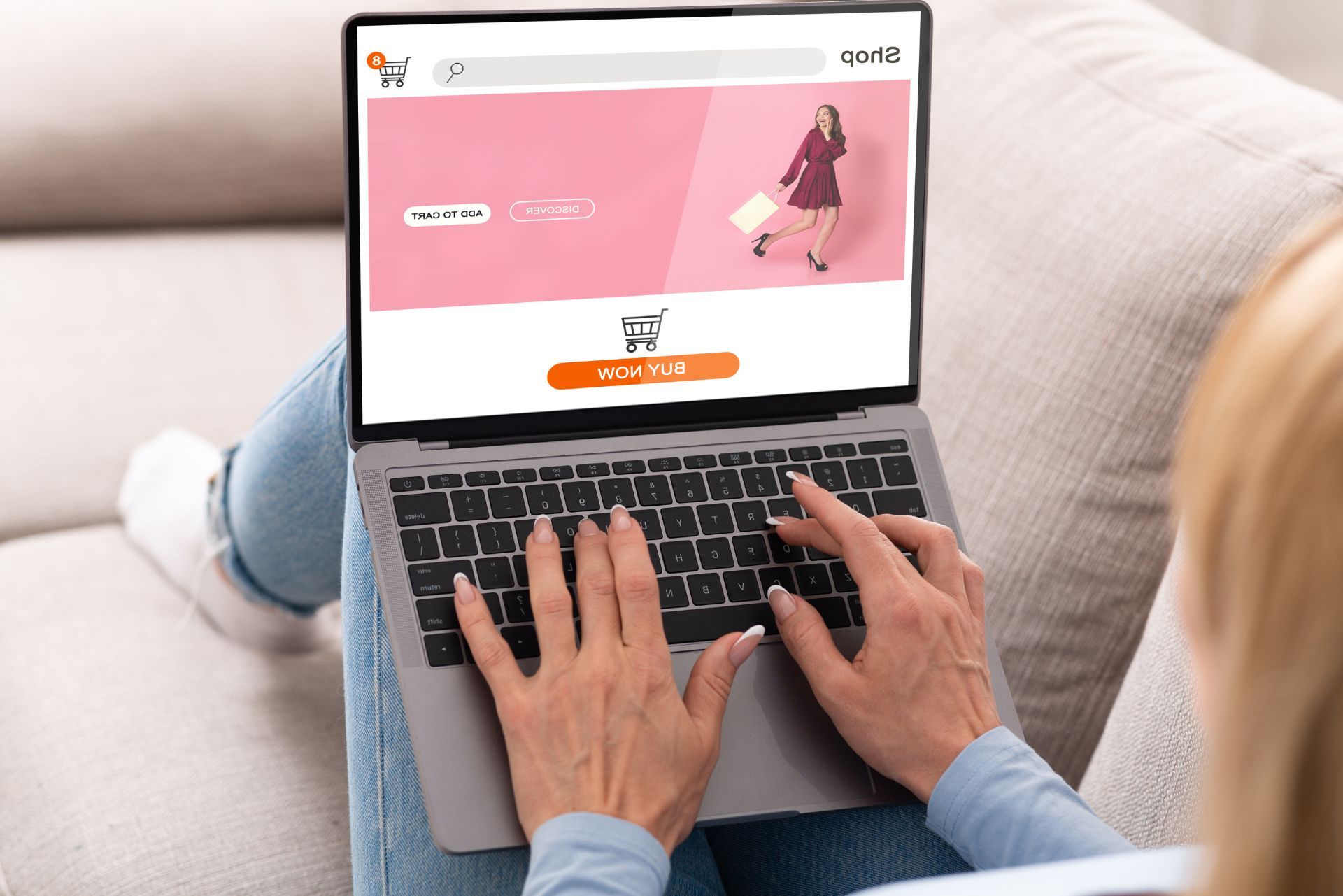 A person sits on a sofa using a laptop to browse an online shopping website with a pink banner.