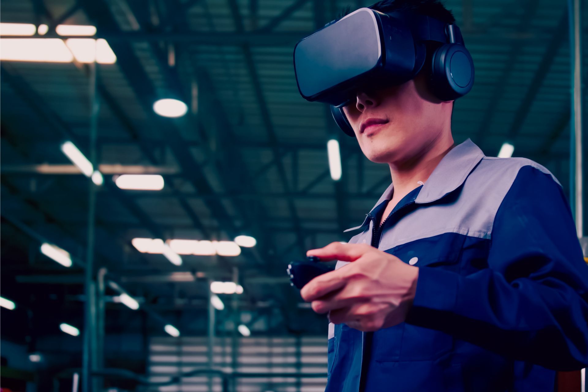 Person wearing a VR headset and blue work jacket in a warehouse, reaching out with a controller