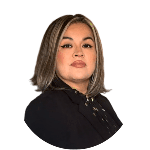 Portrait of a person with shoulder-length highlighted hair wearing a black top against a white background