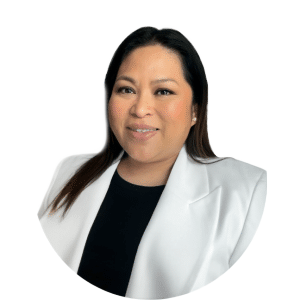 Portrait of a smiling person in a white blazer over a black top on a white background