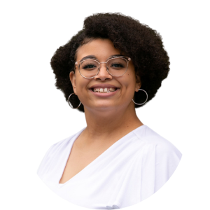Smiling person with glasses and hoop earrings in a white top on a white background