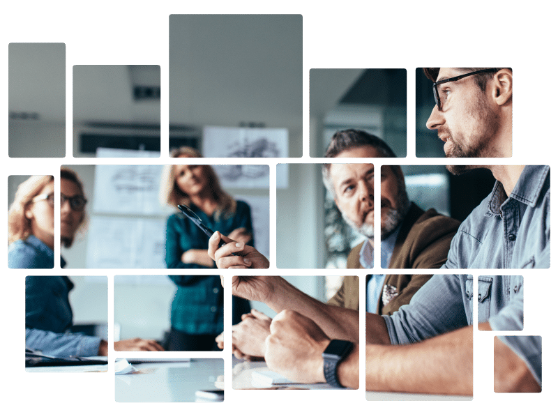 A team of professionals collaborating in a modern office meeting, focusing on a discussion around a table.