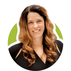 Smiling woman with long wavy hair in a black top on a white and green background