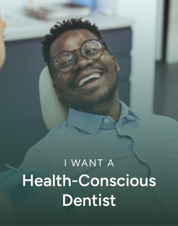 Smiling man in glasses reclines in a dental chair with text: “I WANT A Health-Conscious Dentist”