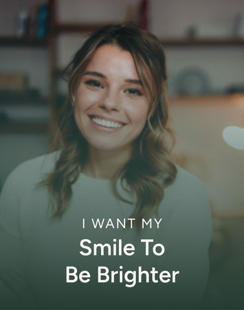 Smiling woman in a bright room with text: “I WANT MY Smile To Be Brighter”