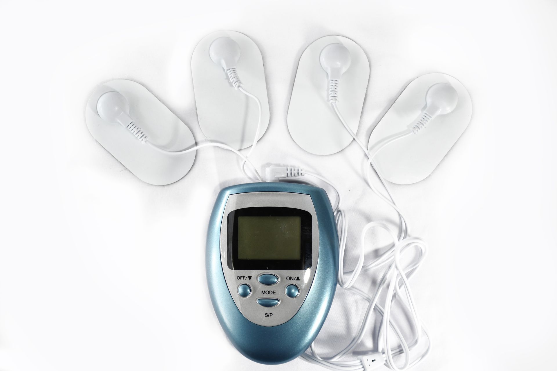 Blue TENS unit with four electrode pads and white wires on a white background