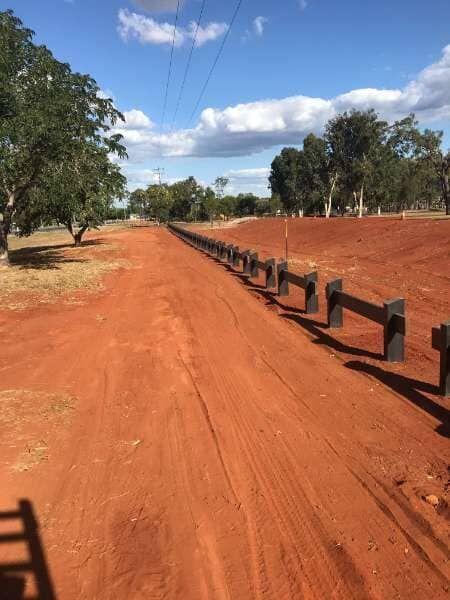 A Dirt Road With A Wooden Fence On The Side Of It — Mulch, Fencing And Landscaping Mackay, QLD