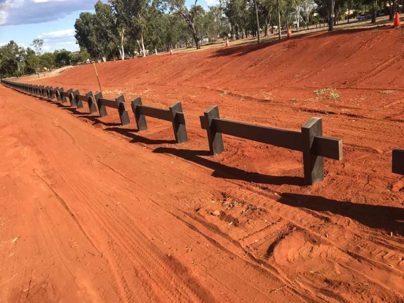 A Row Of Wooden Fences On A Dirt Road — Garden Fencing Installations In Mackay And Surrounds, QLD