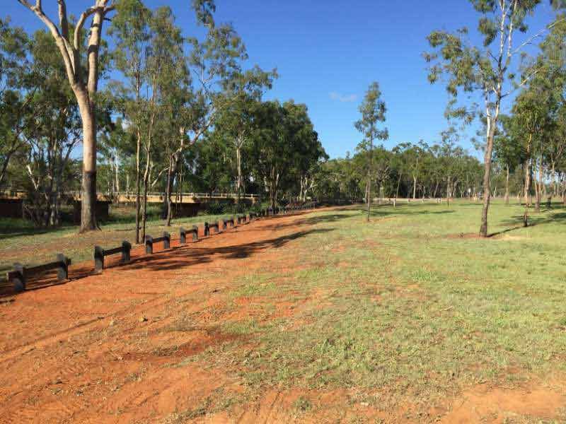 A Dirt Road Going Through A Grassy Field With Trees In The Background — Mulch, Fencing And Landscaping Mackay, QLD