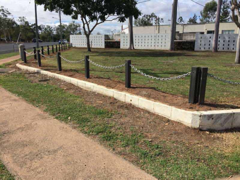 A Chain Link Fence Surrounds A Grassy Area In A Park — Mulch, Fencing And Landscaping Mackay, QLD
