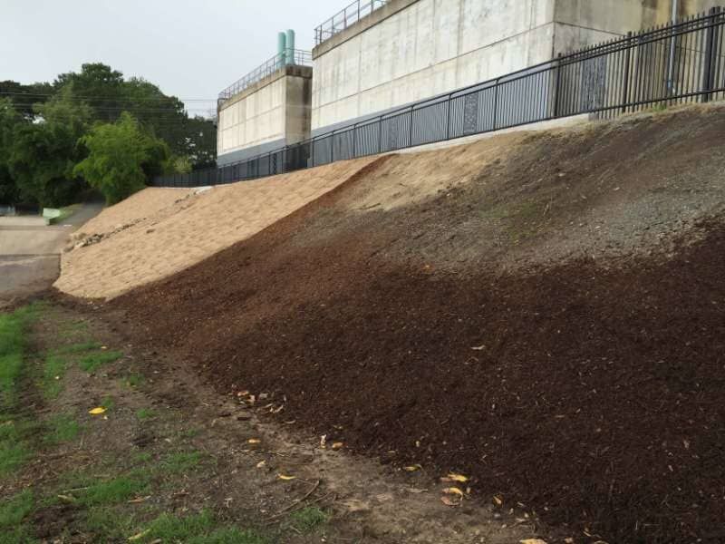 A Large Pile Of Dirt Is Sitting On The Side Of A Hill — Mulch, Fencing And Landscaping Mackay, QLD