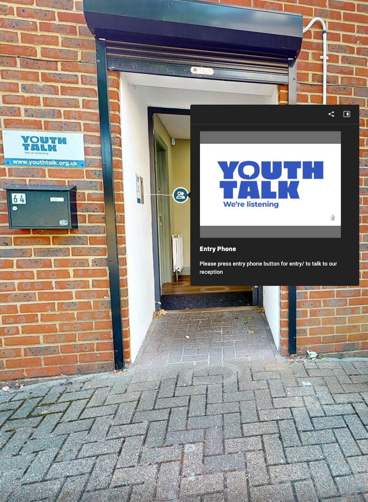 Poster for “YOUTH TALK” displayed in a brick doorway with a small sign and wall-mounted box.