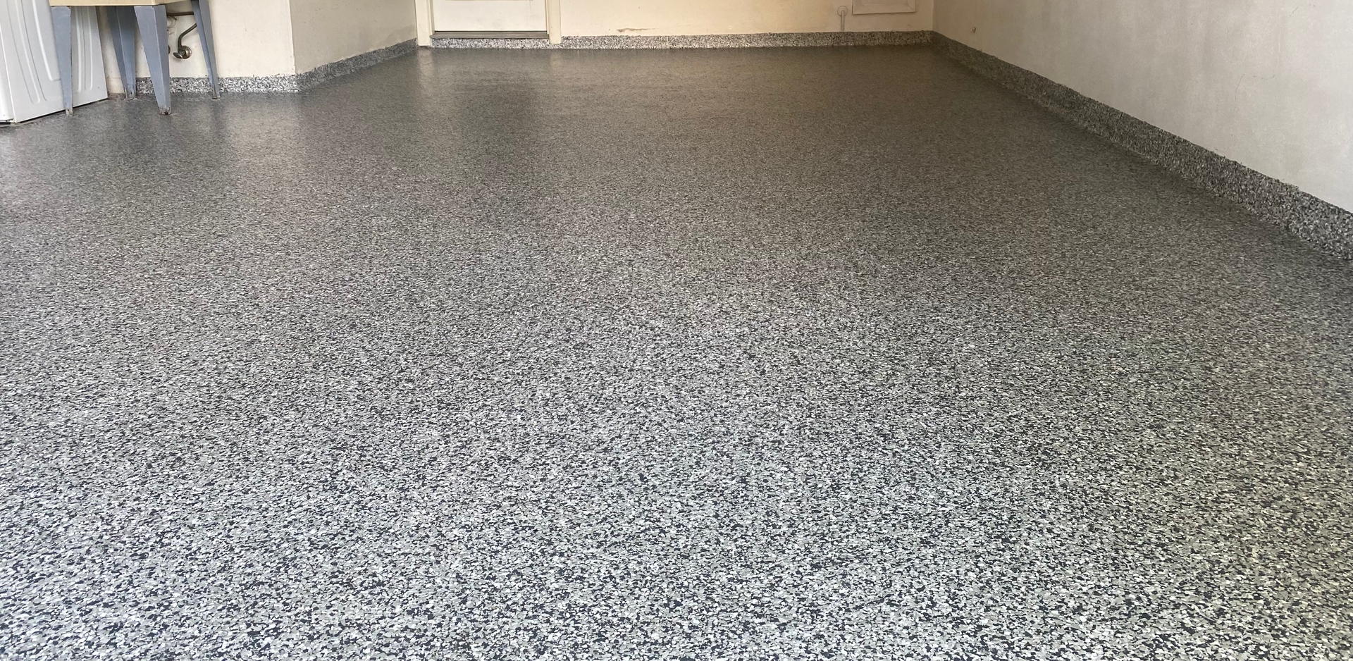 A garage floor with a lot of small stones on it.