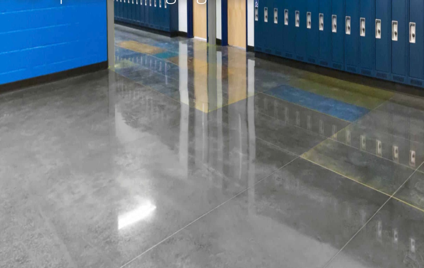 A hallway with lockers and a shiny concrete floor.