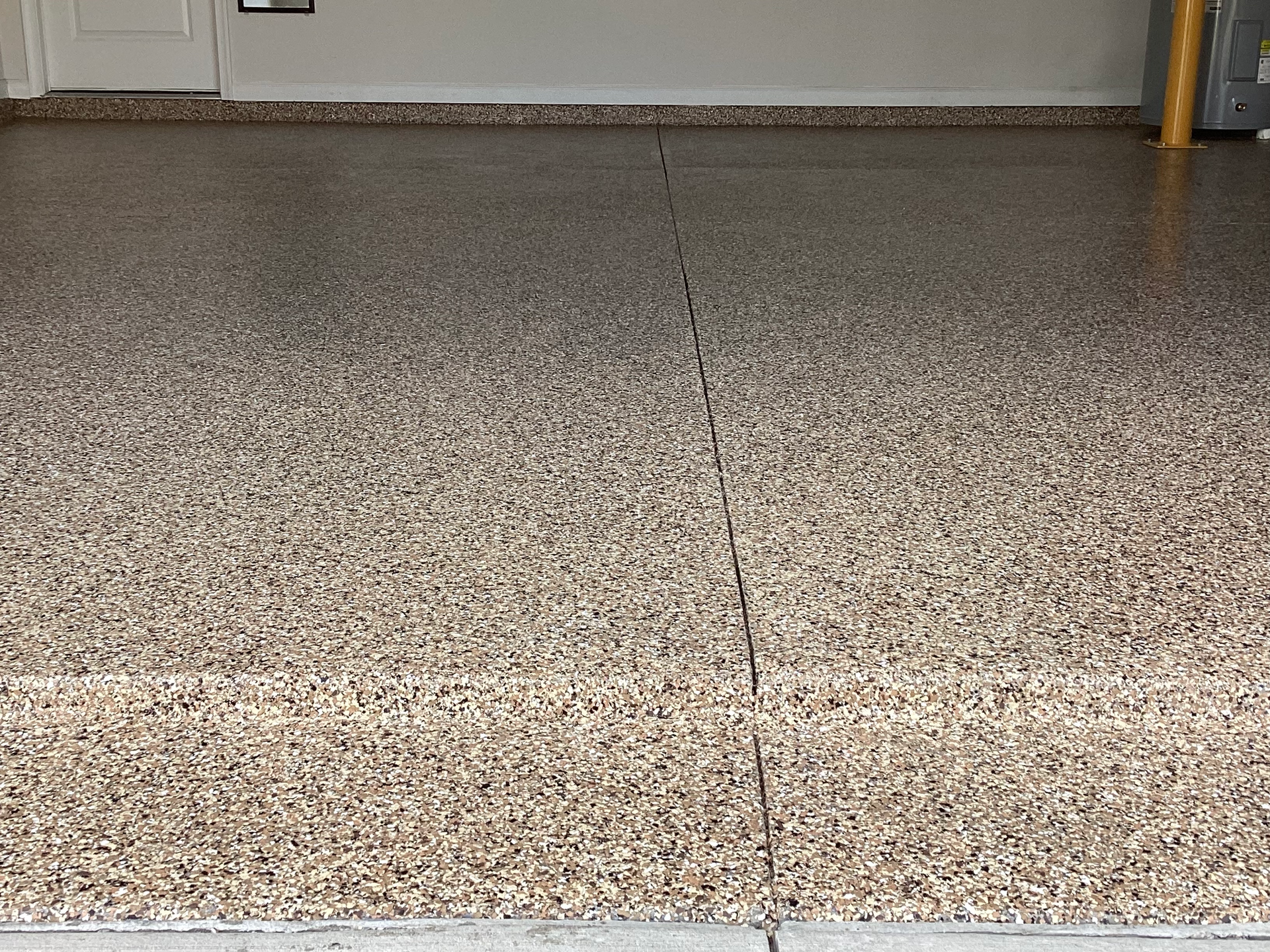 A garage floor with a lot of small stones on it.