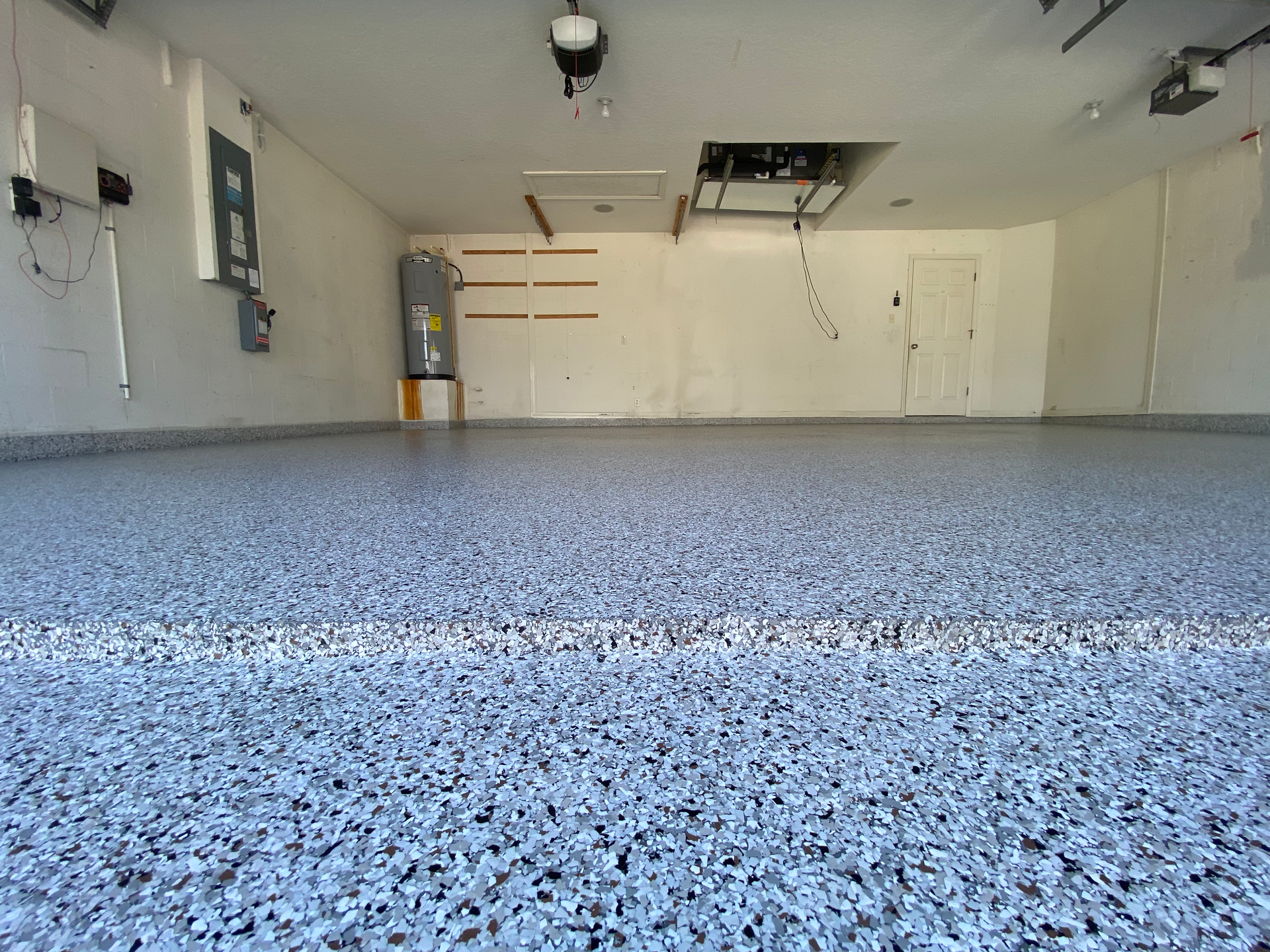 A garage with a blue floor and white walls