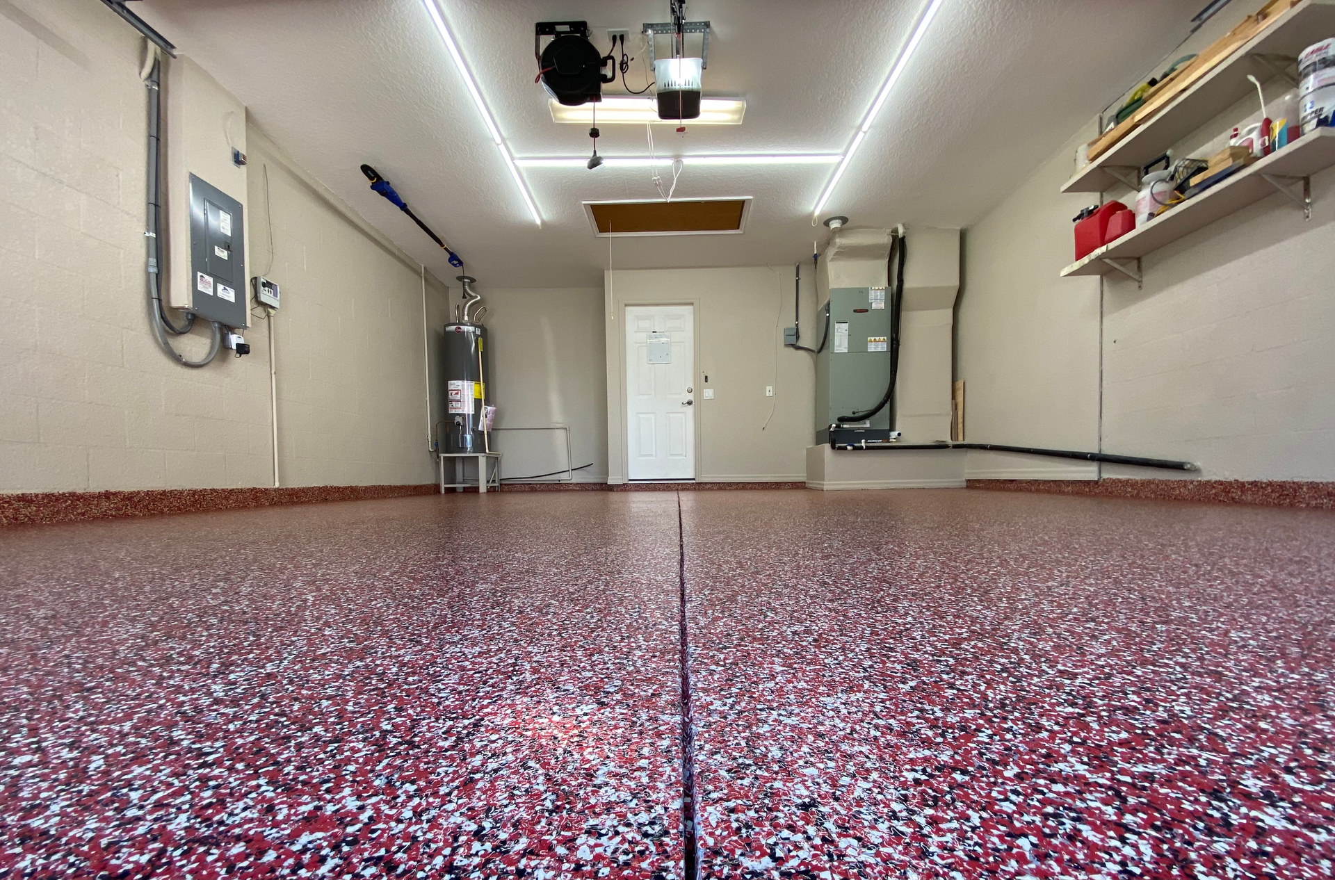 A garage with a red floor and a white door