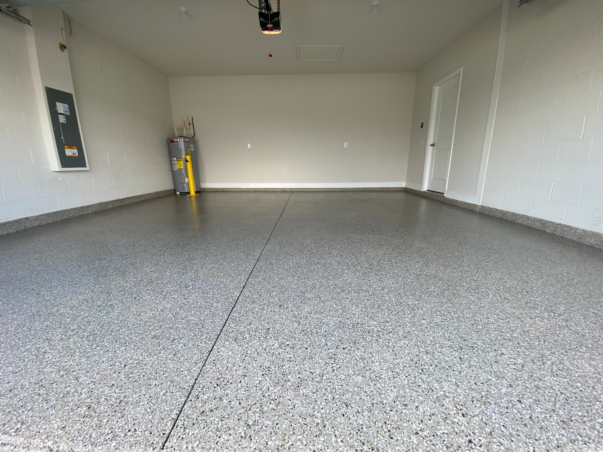 A garage with a gray floor and white walls.