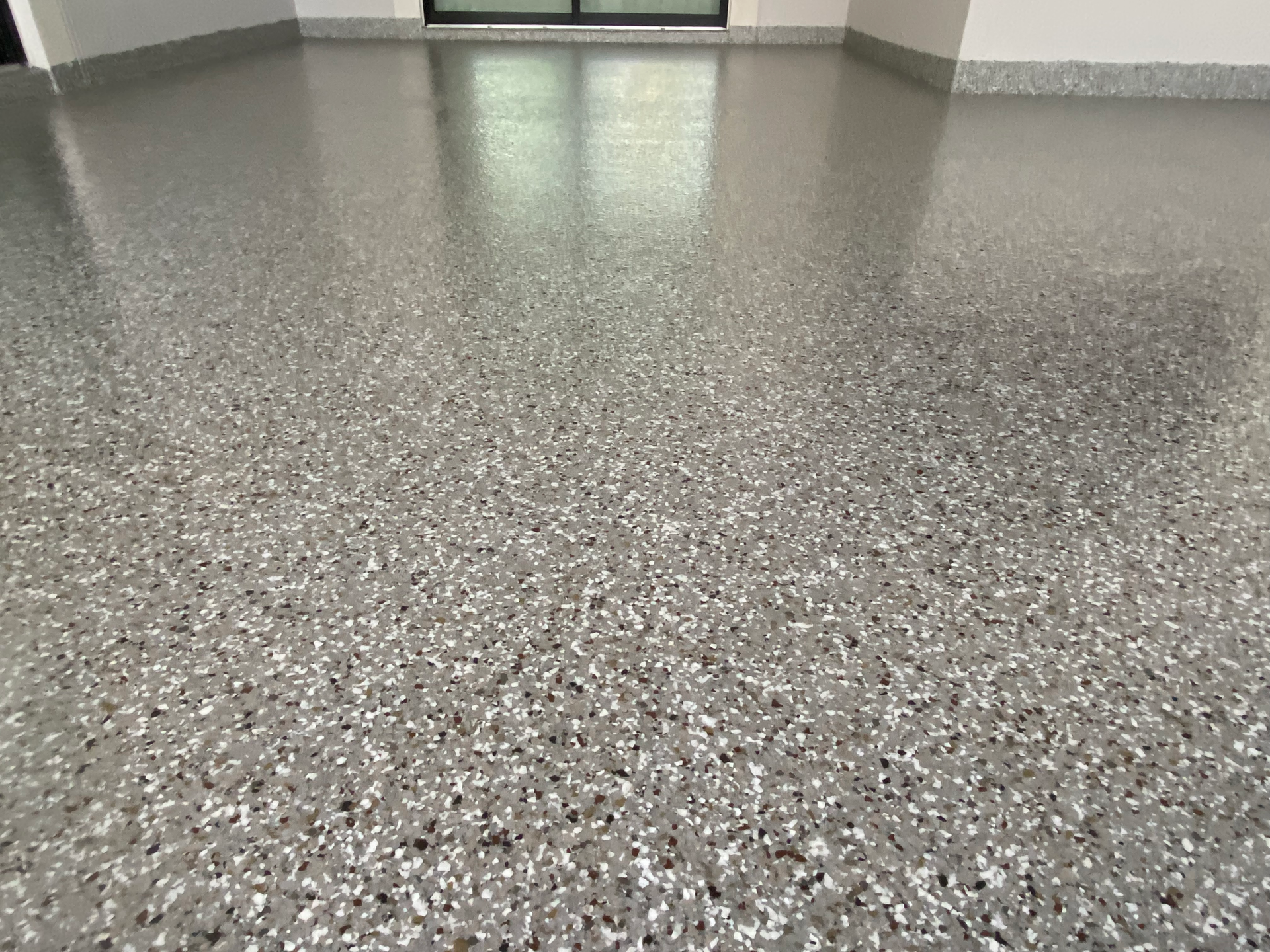 A close up of a gray concrete floor in a room.