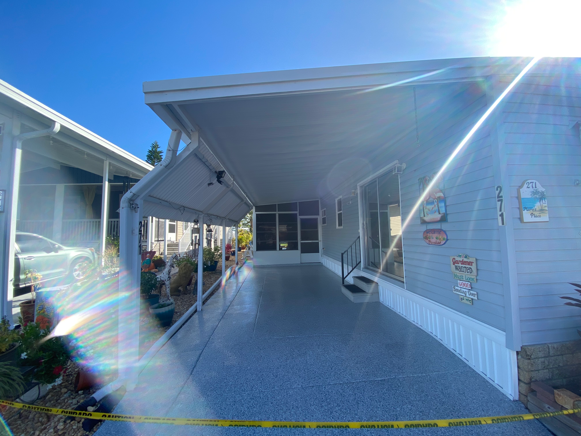 A mobile home with a covered porch and stairs