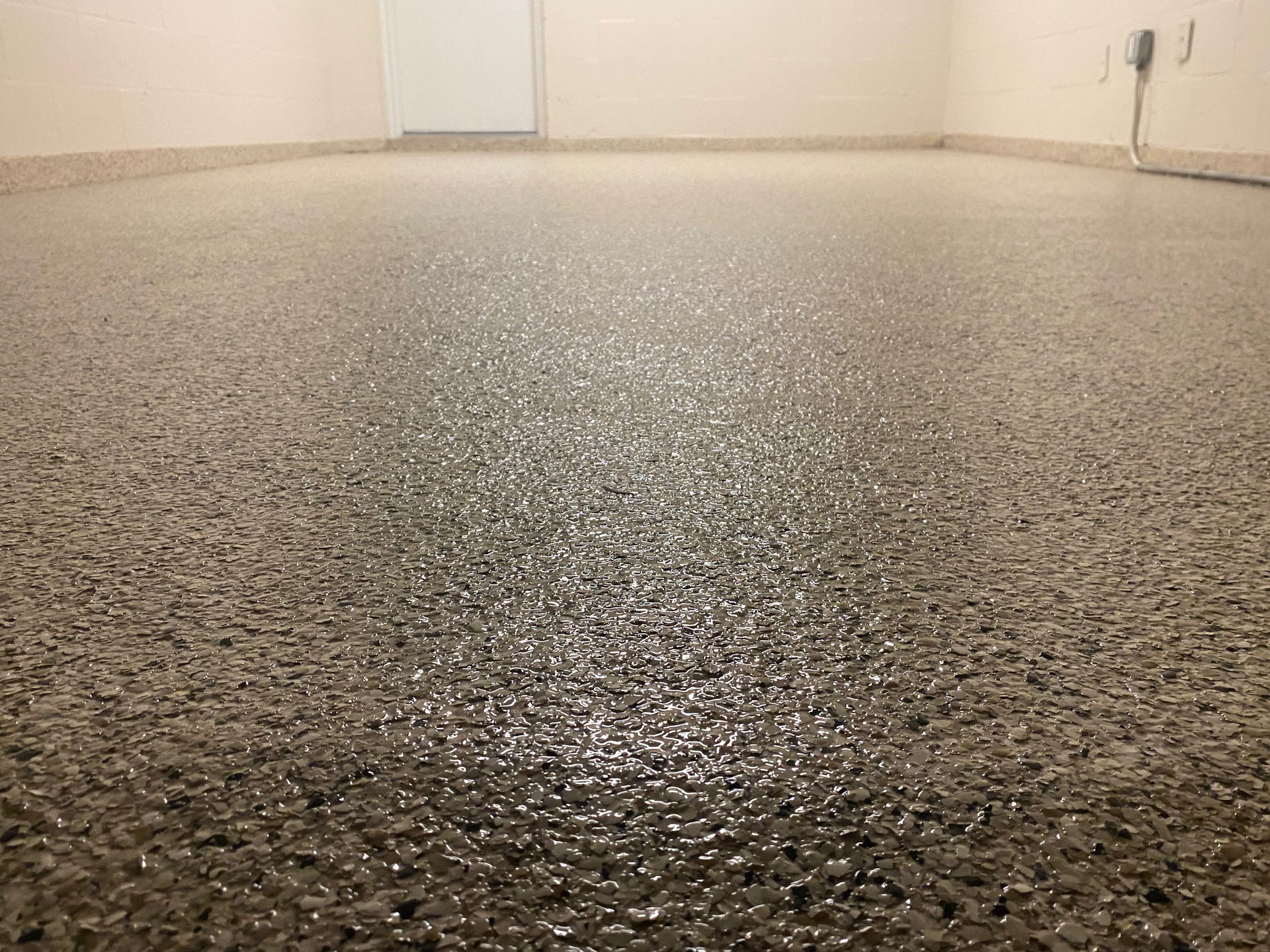A close up of a shiny concrete floor in a room.