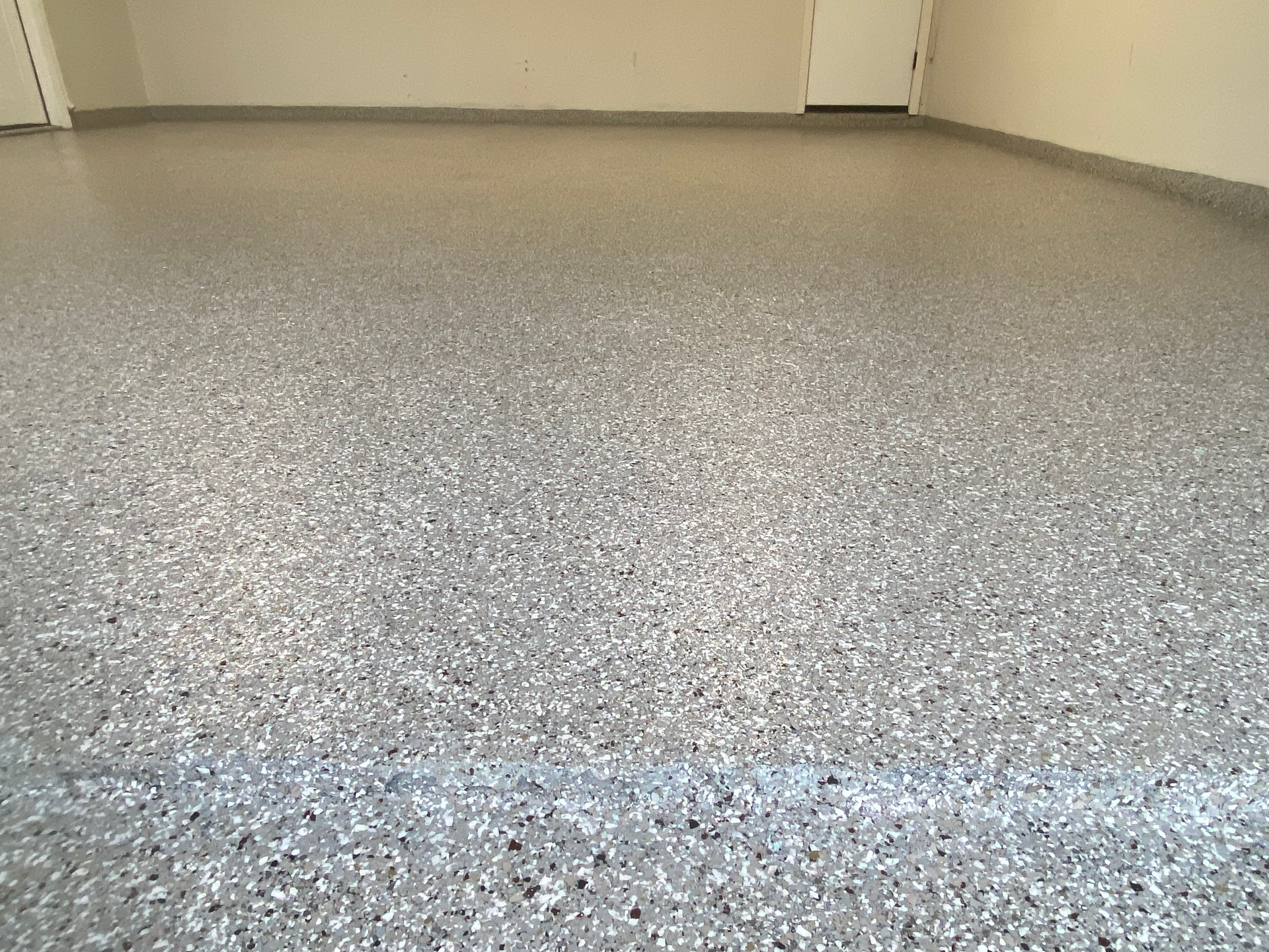 A garage floor with a lot of small stones on it.