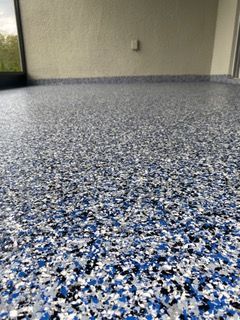 A close up of a blue , white and black floor with a window in the background.