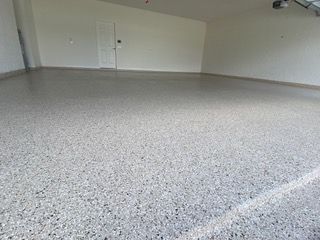 A garage with a concrete floor and white walls.