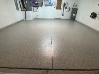 A garage with a concrete floor and a white wall.
