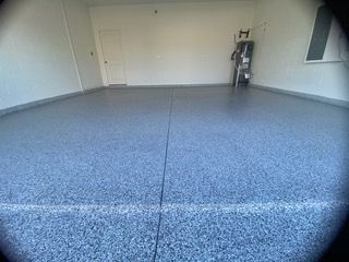 A garage with a blue floor and white walls.