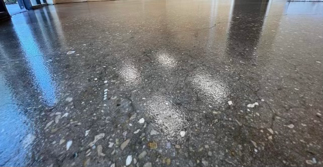 A close up of a shiny concrete floor in a room.