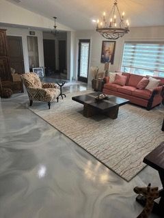 A living room with a couch , chair , coffee table and rug.