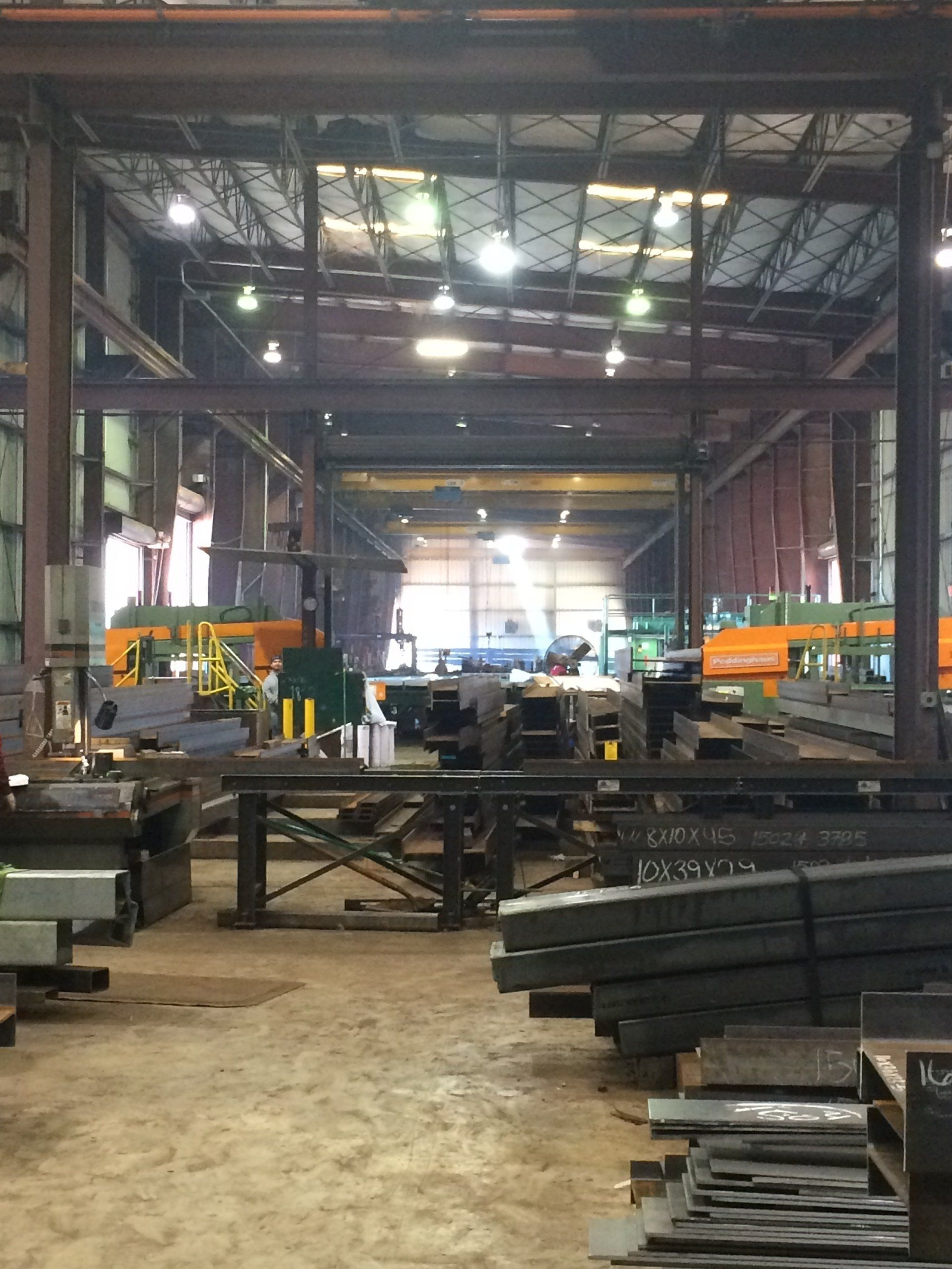 A large warehouse filled with lots of metal pieces and machinery.