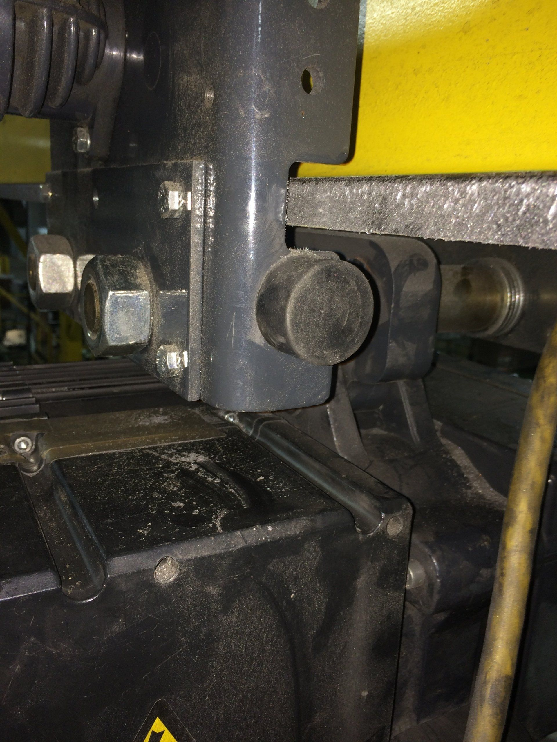 A close up of a machine with a yellow warning sign