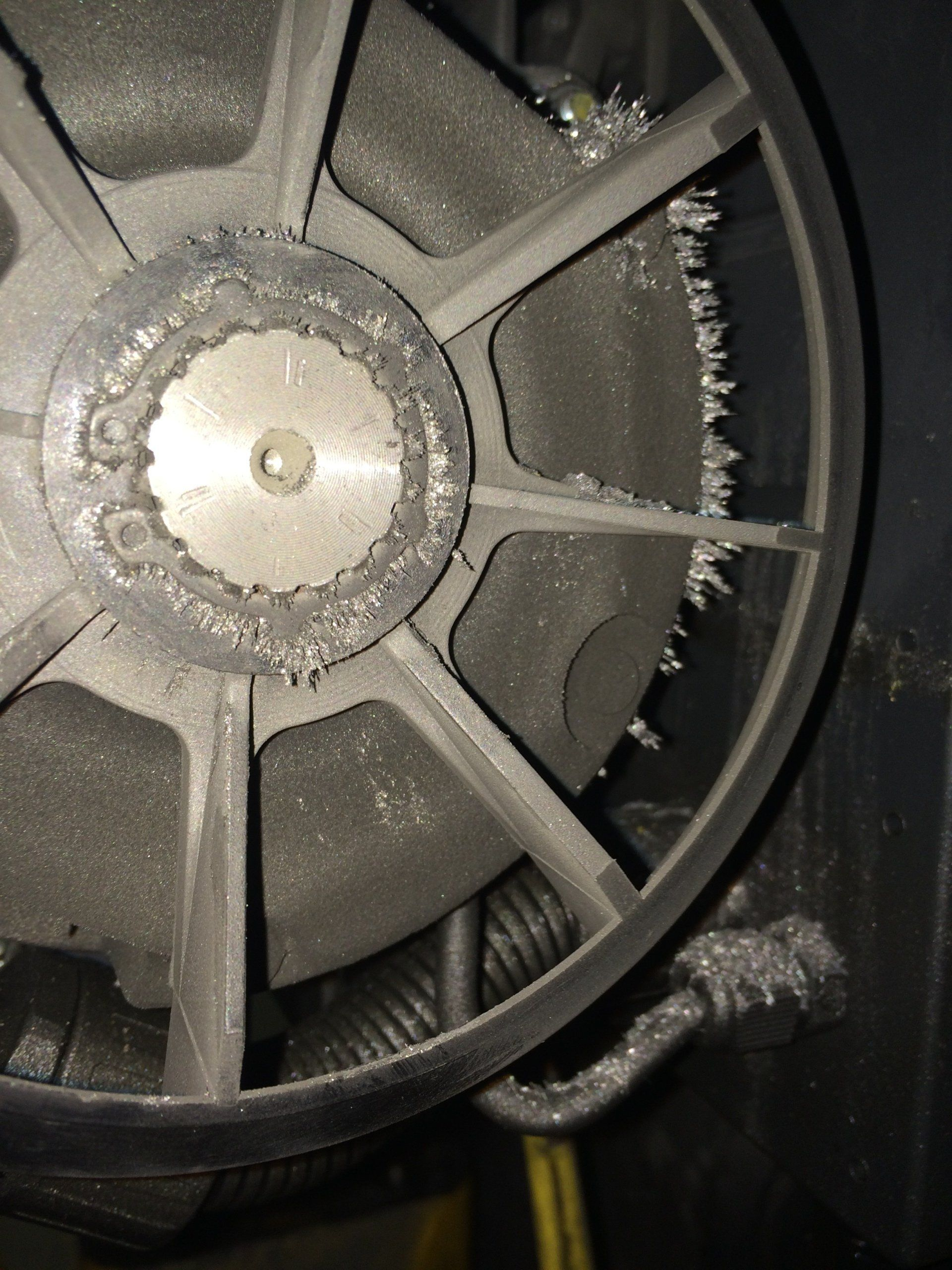 A close up of a fan with a metal gear in the middle