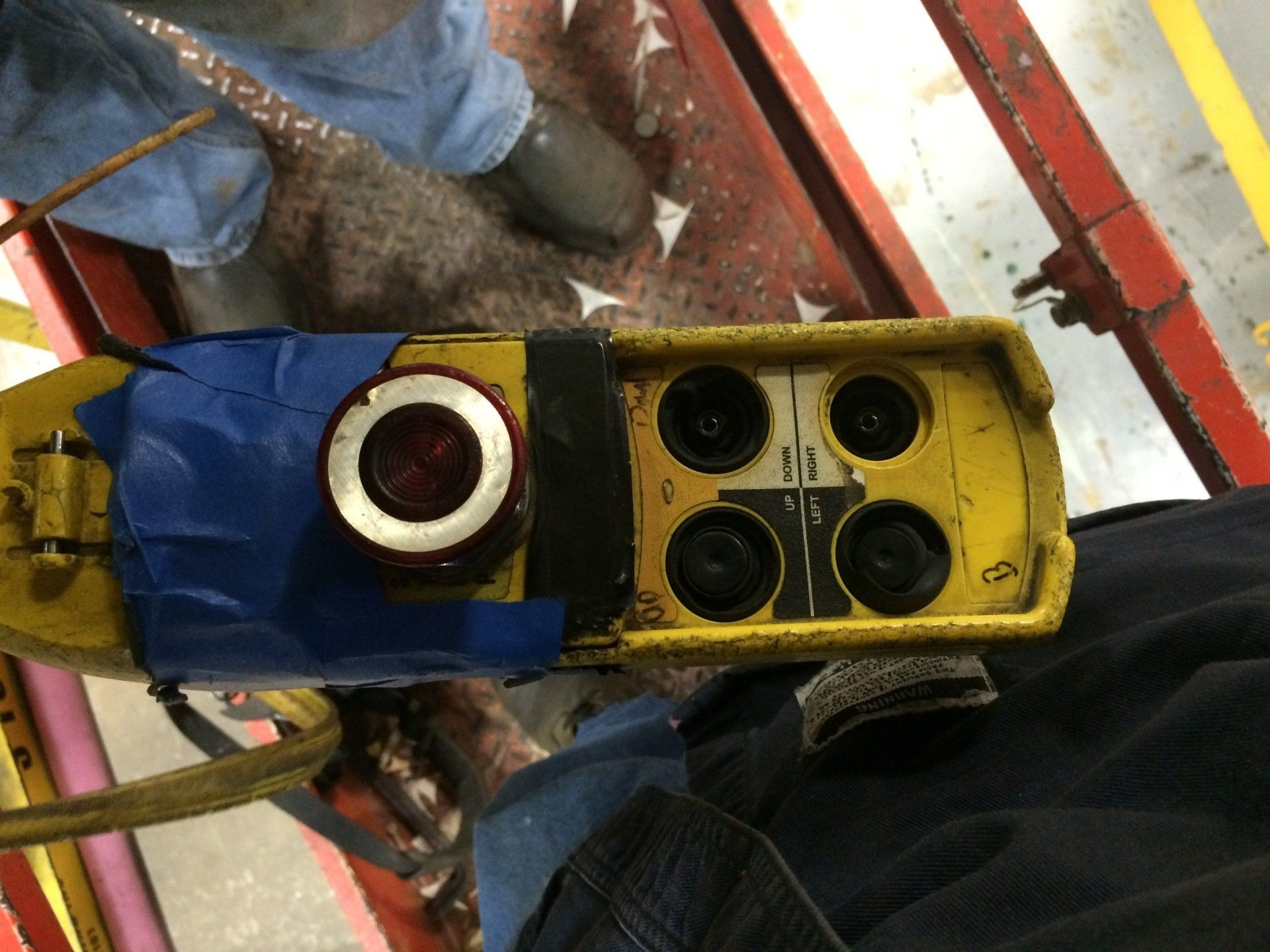 A close up of a remote control with tape on it