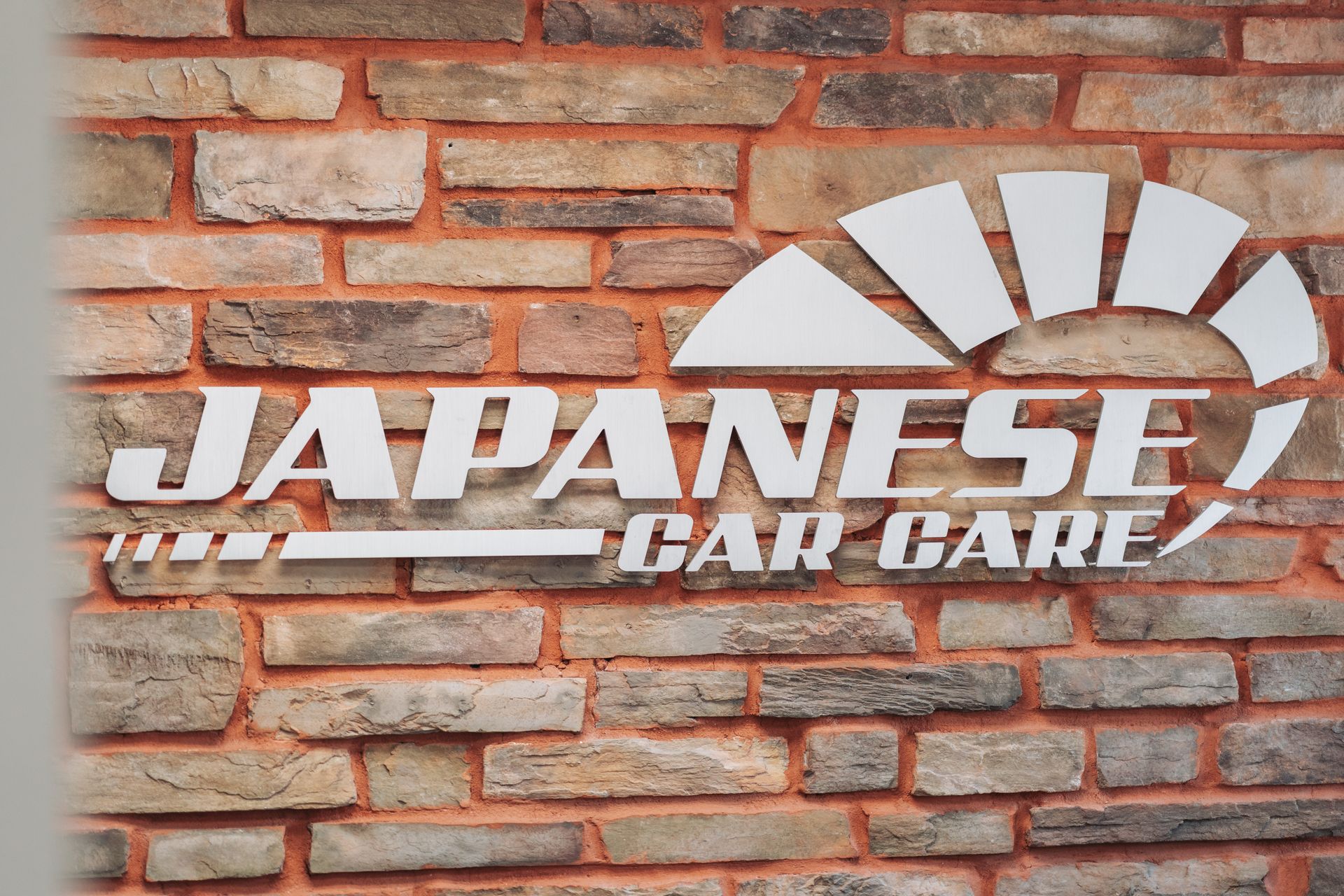 A brick wall with japanese car care written on it | Japanese Car Care