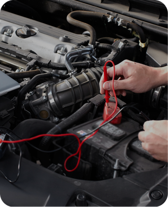 A person is working on the engine of a car | Japanese Car Care