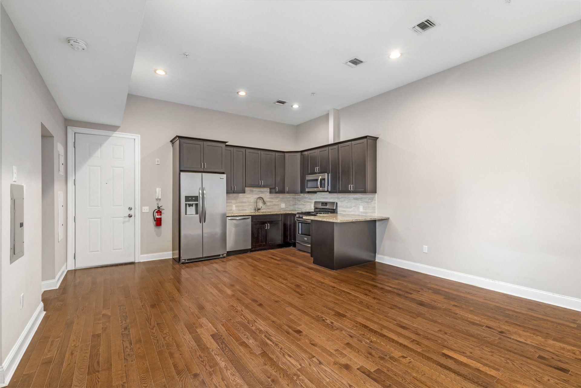 black kitchen with wooden floor