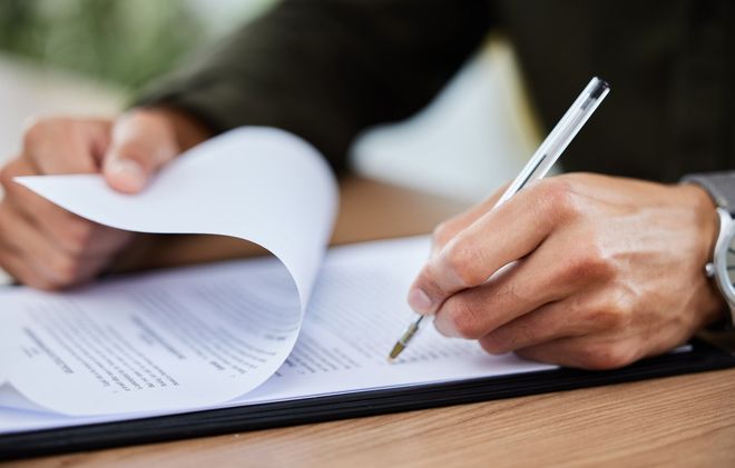 Man signing paperwork