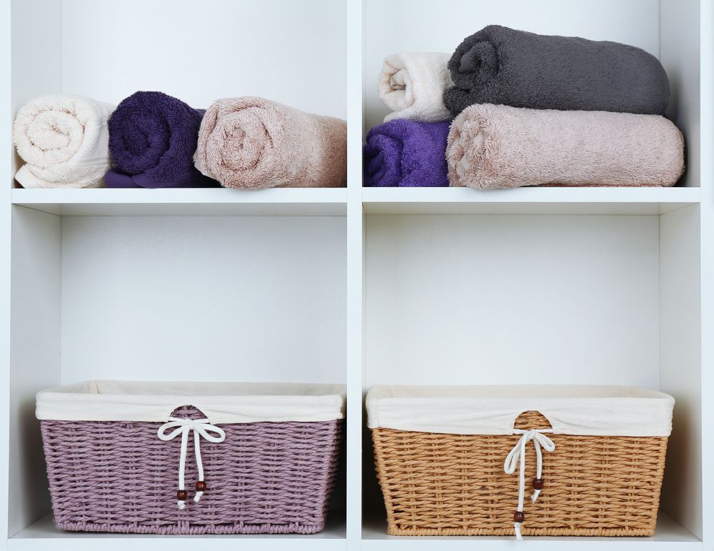Two Baskets Filled With Towels Are Sitting on a Shelf — Super Suds Commercial Laundry in Avoca, QLD