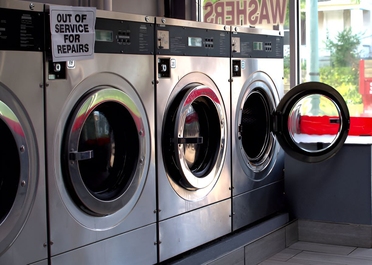 A Row of Washing Machines Are Lined Up in a Laundromat — Super Suds Commercial Laundry in Avoca, QLD