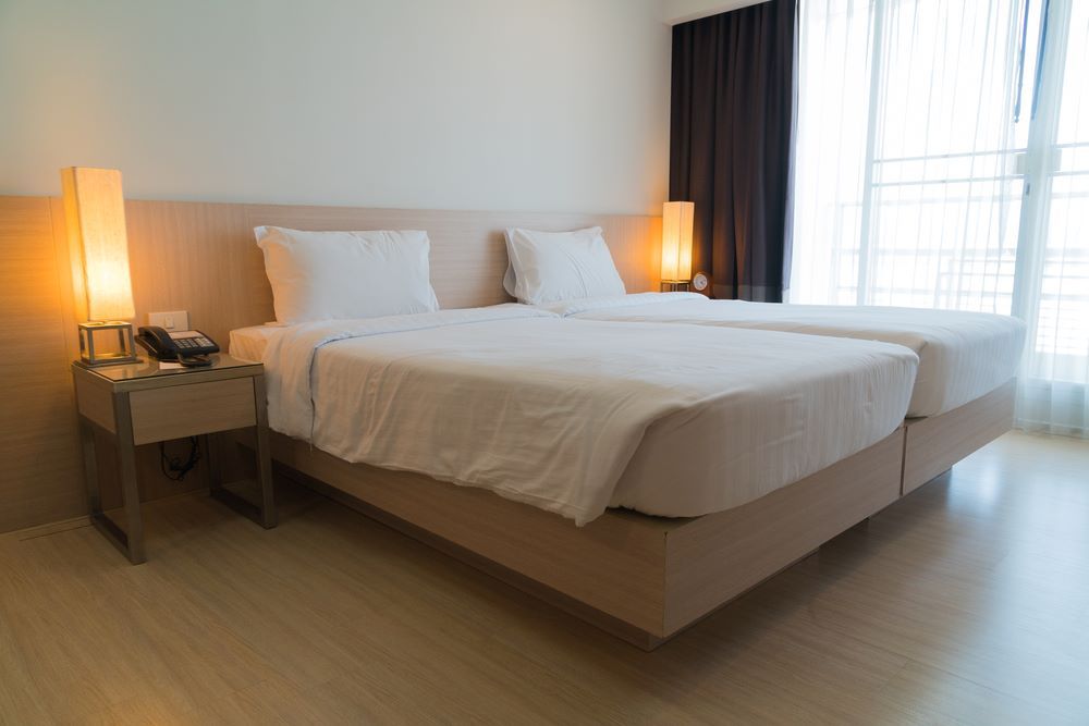 A Hotel Room With Two Beds and a Nightstand — Super Suds Laundry in Avoca, QLD
