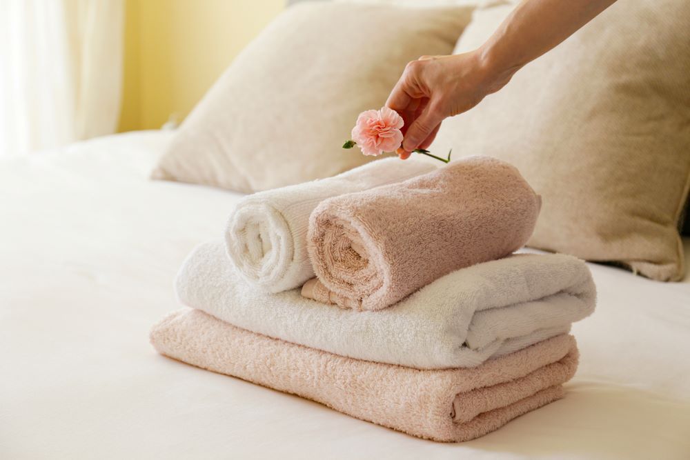 A Stack of Towels on a Bed — Super Suds Laundry in Avoca, QLD